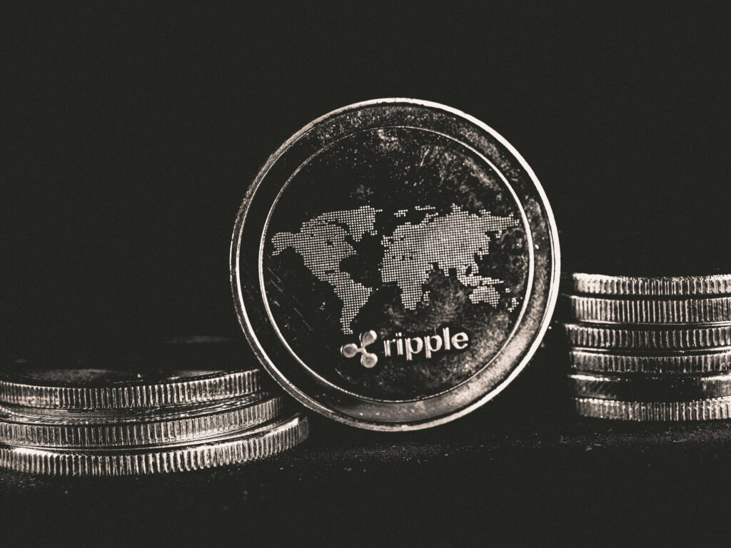 A detailed shot of a Ripple coin with a world map design on a black background.